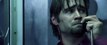 Movie still from “Phone Booth” (2002), directed by Joel Schumacher – A person wearing a pair of ear buds; Close Up shot, Over the shoulder angle