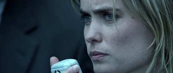 Movie still from “Phone Booth” (2002), directed by Joel Schumacher – A woman holding a remote control in her hand; Close Up shot, Low angle