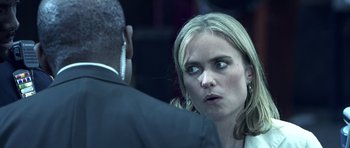 Movie still from “Phone Booth” (2002), directed by Joel Schumacher – A woman is looking at a man in a black suit; Close Up shot, Over the shoulder angle