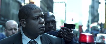 Movie still from “Phone Booth” (2002), directed by Joel Schumacher – A man taking a picture of another man with a cell phone; Close Up shot, Low angle