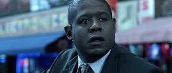 Movie still from “Phone Booth” (2002), directed by Joel Schumacher – A person wearing a suit and tie; Close Up shot, Low angle