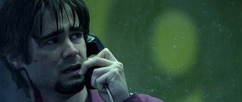 Movie still from “Phone Booth” (2002), directed by Joel Schumacher – A person talking on a cell phone; Close Up shot, Over the shoulder angle