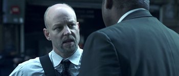 Movie still from “Phone Booth” (2002), directed by Joel Schumacher – A man in a business suit talking to another man in a business suit; Close Up shot, Over the shoulder angle