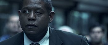 Movie still from “Phone Booth” (2002), directed by Joel Schumacher – A person wearing a suit and tie; Close Up shot, Low angle