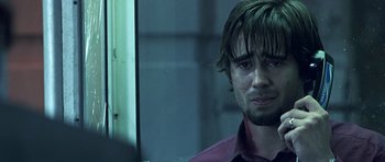 Movie still from “Phone Booth” (2002), directed by Joel Schumacher – A person wearing a red shirt; Close Up shot, Over the shoulder angle