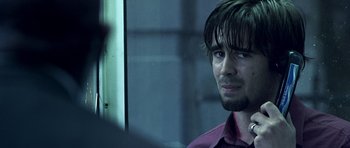 Movie still from “Phone Booth” (2002), directed by Joel Schumacher – A person wearing a red shirt; Close Up shot, Over the shoulder angle