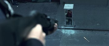 Movie still from “Phone Booth” (2002), directed by Joel Schumacher – A person is taking a picture of a phone booth; Wide shot, Overhead angle