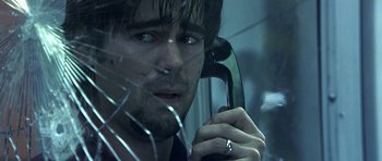 Movie still from “Phone Booth” (2002), directed by Joel Schumacher – A person talking on a phone; Close Up shot, Low angle