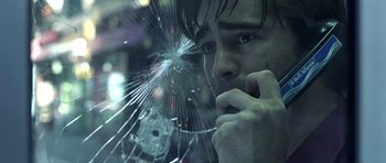 Movie still from “Phone Booth” (2002), directed by Joel Schumacher – A man looking through a shattered window; Close Up shot, Low angle