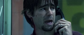 Movie still from “Phone Booth” (2002), directed by Joel Schumacher – A person talking on a cell phone; Close Up shot, Low angle