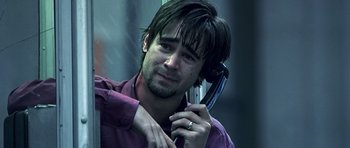 Movie still from “Phone Booth” (2002), directed by Joel Schumacher – A man holding a phone up to his ear; Close Up shot, High angle