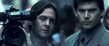 Movie still from “Phone Booth” (2002), directed by Joel Schumacher – A person wearing a headset; Close Up shot, Low angle