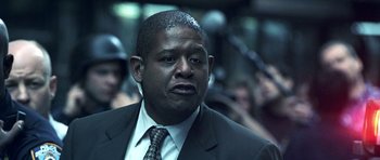 Movie still from “Phone Booth” (2002), directed by Joel Schumacher – A person wearing a suit and tie; Close Up shot, Low angle