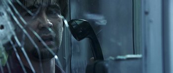 Movie still from “Phone Booth” (2002), directed by Joel Schumacher – A man holding a phone up to his ear; Close Up shot, Low angle