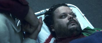 Movie still from “Phone Booth” (2002), directed by Joel Schumacher – A man laying in a hospital bed with blood pouring out of his head; Close Up shot, Overhead angle