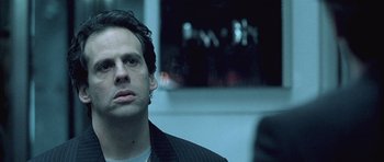 Movie still from “Phone Booth” (2002), directed by Joel Schumacher – A person wearing a suit; Close Up shot, Low angle