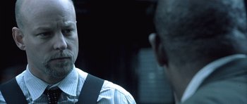 Movie still from “Phone Booth” (2002), directed by Joel Schumacher – Two men are talking in a dark room; Close Up shot, Over the shoulder angle