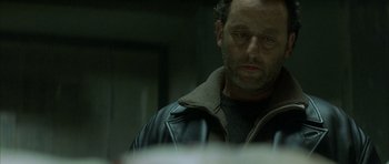 Movie still from “The Crimson Rivers” (2000), directed by Mathieu Kassovitz – A person wearing a leather jacket; Close Up shot, Overhead angle