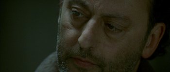 Movie still from “The Crimson Rivers” (2000), directed by Mathieu Kassovitz – A man's face as he stares into the distance; Extreme Close Up shot, Over the shoulder angle