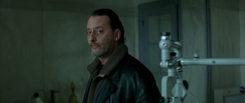 Movie still from “The Crimson Rivers” (2000), directed by Mathieu Kassovitz – A person wearing a leather jacket; Close Up shot, Low angle