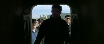 Movie still from “The Crimson Rivers” (2000), directed by Mathieu Kassovitz – A group of men standing in front of each other; Medium shot, Low angle