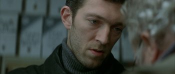 Movie still from “The Crimson Rivers” (2000), directed by Mathieu Kassovitz – A person wearing a jacket; Close Up shot, Over the shoulder angle