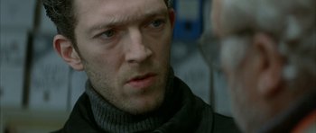 Movie still from “The Crimson Rivers” (2000), directed by Mathieu Kassovitz – A person wearing a jacket; Close Up shot, Over the shoulder angle