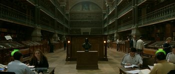 Movie still from “The Crimson Rivers” (2000), directed by Mathieu Kassovitz – A library filled with lots of books and people; Extreme Wide shot, High angle