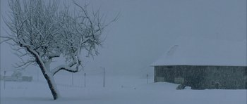 Movie still from “The Crimson Rivers” (2000), directed by Mathieu Kassovitz – A barn in the middle of a snow covered field; Extreme Wide shot, High angle