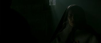 Movie still from “The Crimson Rivers” (2000), directed by Mathieu Kassovitz – A woman in a hooded cloak in a dark room; Close Up shot, Low angle