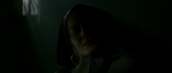 Movie still from “The Crimson Rivers” (2000), directed by Mathieu Kassovitz – A woman in a hooded jacket is in the dark; Close Up shot, Low angle