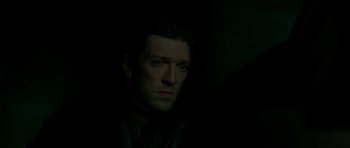 Movie still from “The Crimson Rivers” (2000), directed by Mathieu Kassovitz – A person wearing a suit and tie; Close Up shot, Low angle