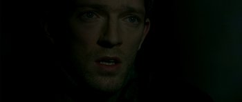 Movie still from “The Crimson Rivers” (2000), directed by Mathieu Kassovitz – A man's face in the dark; Close Up shot, High angle