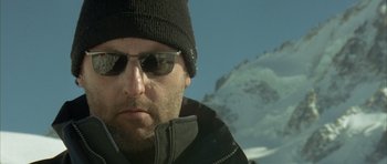 Movie still from “The Crimson Rivers” (2000), directed by Mathieu Kassovitz – A person wearing sunglasses and a hat; Close Up shot, Low angle