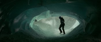 Movie still from “The Crimson Rivers” (2000), directed by Mathieu Kassovitz – A man standing inside of an ice cave; Wide shot, High angle