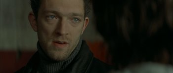 Movie still from “The Crimson Rivers” (2000), directed by Mathieu Kassovitz – A person wearing a black jacket; Close Up shot, Over the shoulder angle