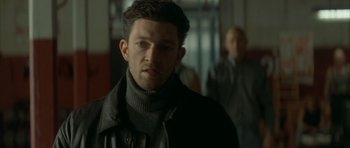Movie still from “The Crimson Rivers” (2000), directed by Mathieu Kassovitz – A person wearing a jacket; Close Up shot, Over the shoulder angle