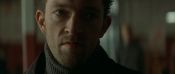 Movie still from “The Crimson Rivers” (2000), directed by Mathieu Kassovitz – A person wearing a sweater; Close Up shot, Low angle
