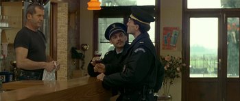 Movie still from “The Crimson Rivers” (2000), directed by Mathieu Kassovitz – Two police officers standing next to each other holding a wine glass; Medium shot, Over the shoulder angle