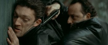 Movie still from “The Crimson Rivers” (2000), directed by Mathieu Kassovitz – Two men are combing each other's hair; Close Up shot, Over the shoulder angle