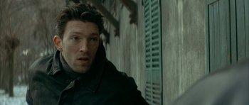 Movie still from “The Crimson Rivers” (2000), directed by Mathieu Kassovitz – A person wearing a jacket; Close Up shot, Over the shoulder angle