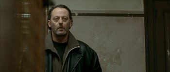 Movie still from “The Crimson Rivers” (2000), directed by Mathieu Kassovitz – A person wearing a leather jacket; Close Up shot, Over the shoulder angle