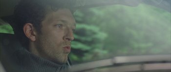 Movie still from “The Crimson Rivers” (2000), directed by Mathieu Kassovitz – A person in a car looking out the window; Close Up shot, Low angle