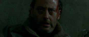 Movie still from “The Crimson Rivers” (2000), directed by Mathieu Kassovitz – A person with blood on his face; Close Up shot, Low angle