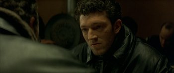 Movie still from “The Crimson Rivers” (2000), directed by Mathieu Kassovitz – A person wearing a black jacket; Close Up shot, Over the shoulder angle