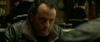 Movie still from “The Crimson Rivers” (2000), directed by Mathieu Kassovitz – A person wearing a leather jacket; Close Up shot, Over the shoulder angle