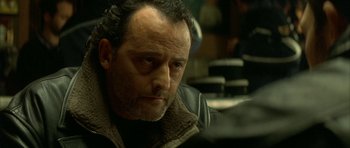 Movie still from “The Crimson Rivers” (2000), directed by Mathieu Kassovitz – A person wearing a jacket; Close Up shot, Over the shoulder angle