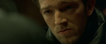 Movie still from “The Crimson Rivers” (2000), directed by Mathieu Kassovitz – A man's face in a dimly - lit room; Extreme Close Up shot, High angle