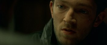 Movie still from “The Crimson Rivers” (2000), directed by Mathieu Kassovitz – A man's face in a dark room; Extreme Close Up shot, High angle