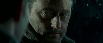 Movie still from “The Crimson Rivers” (2000), directed by Mathieu Kassovitz – A man's face in the dark; Close Up shot, Over the shoulder angle